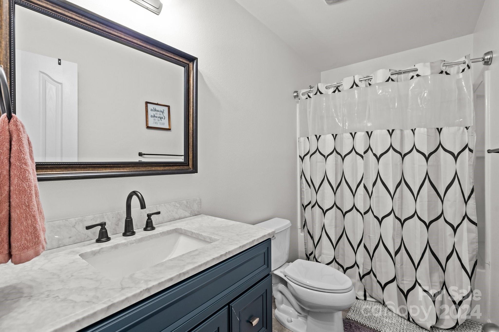 5511 Keener Ridge Road Charlotte, NC 28216 - Photo 17 of 31 a bathroom with a granite countertop sink and a toilet