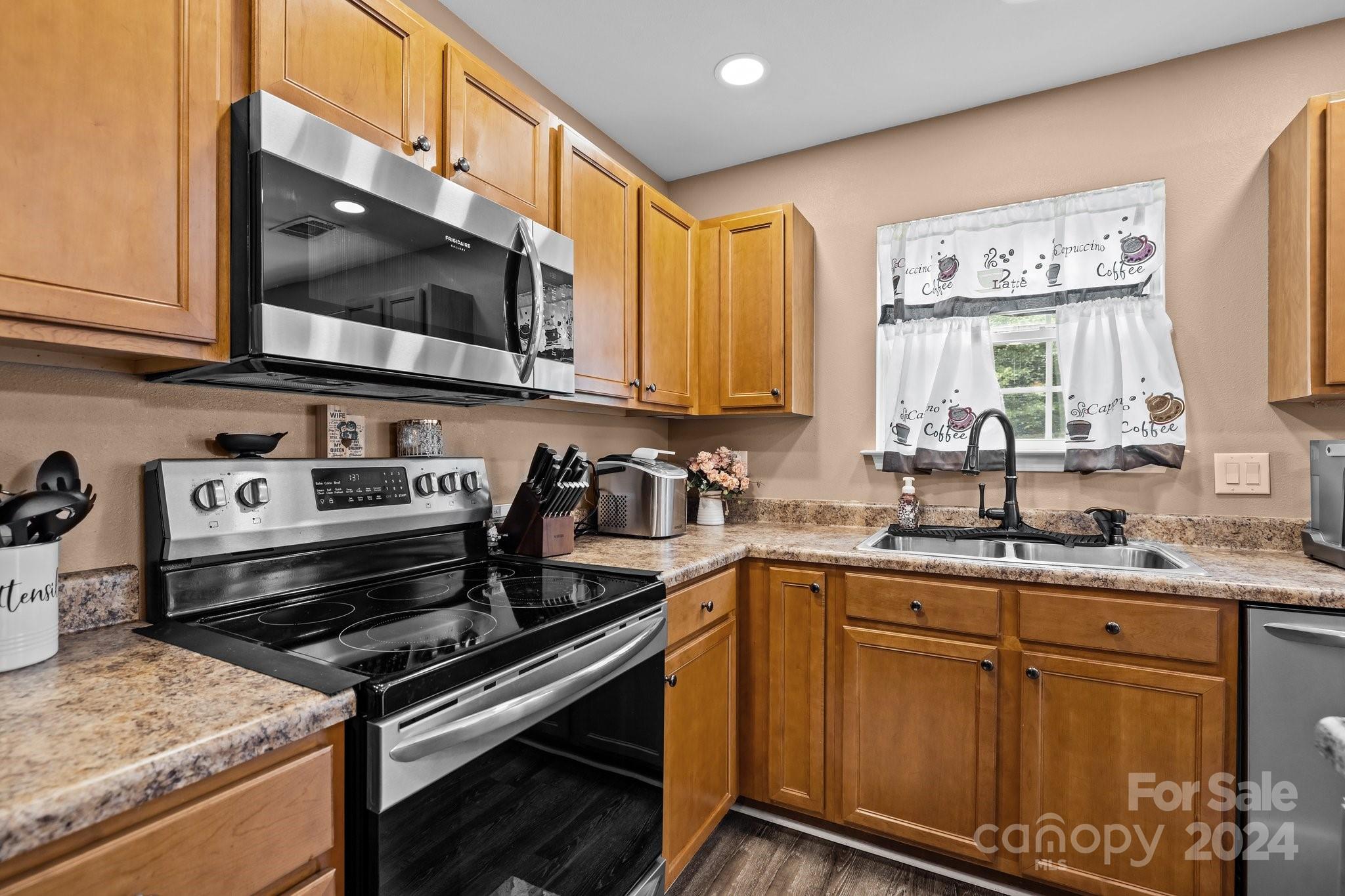 5511 Keener Ridge Road Charlotte, NC 28216 - Photo 25 of 31 a kitchen with stainless steel appliances a stove sink and microwave