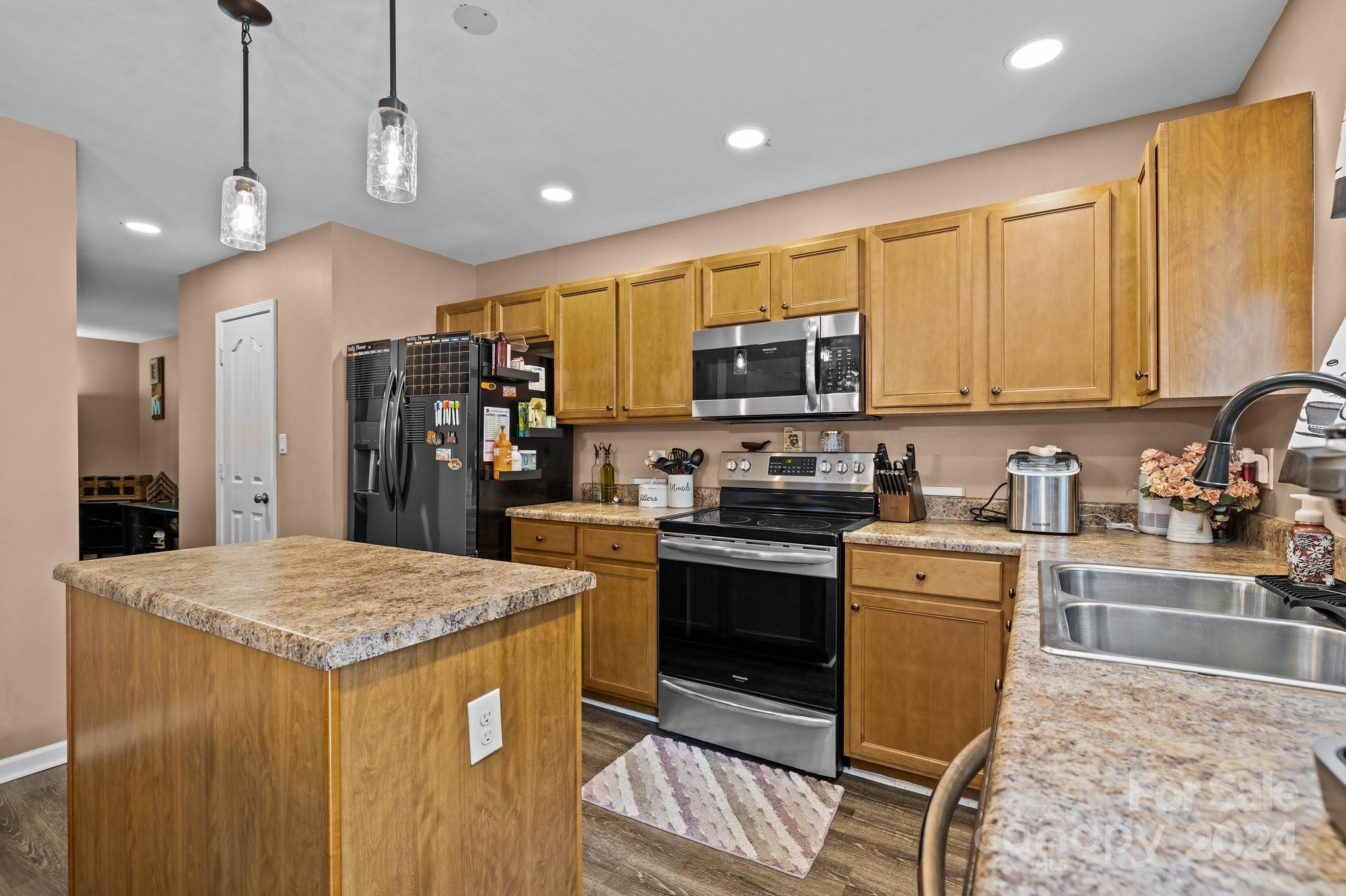 5511 Keener Ridge Road Charlotte, NC 28216 - Photo 26 of 31 a kitchen with stainless steel appliances granite countertop a sink a stove a refrigerator cabinets and a dining table