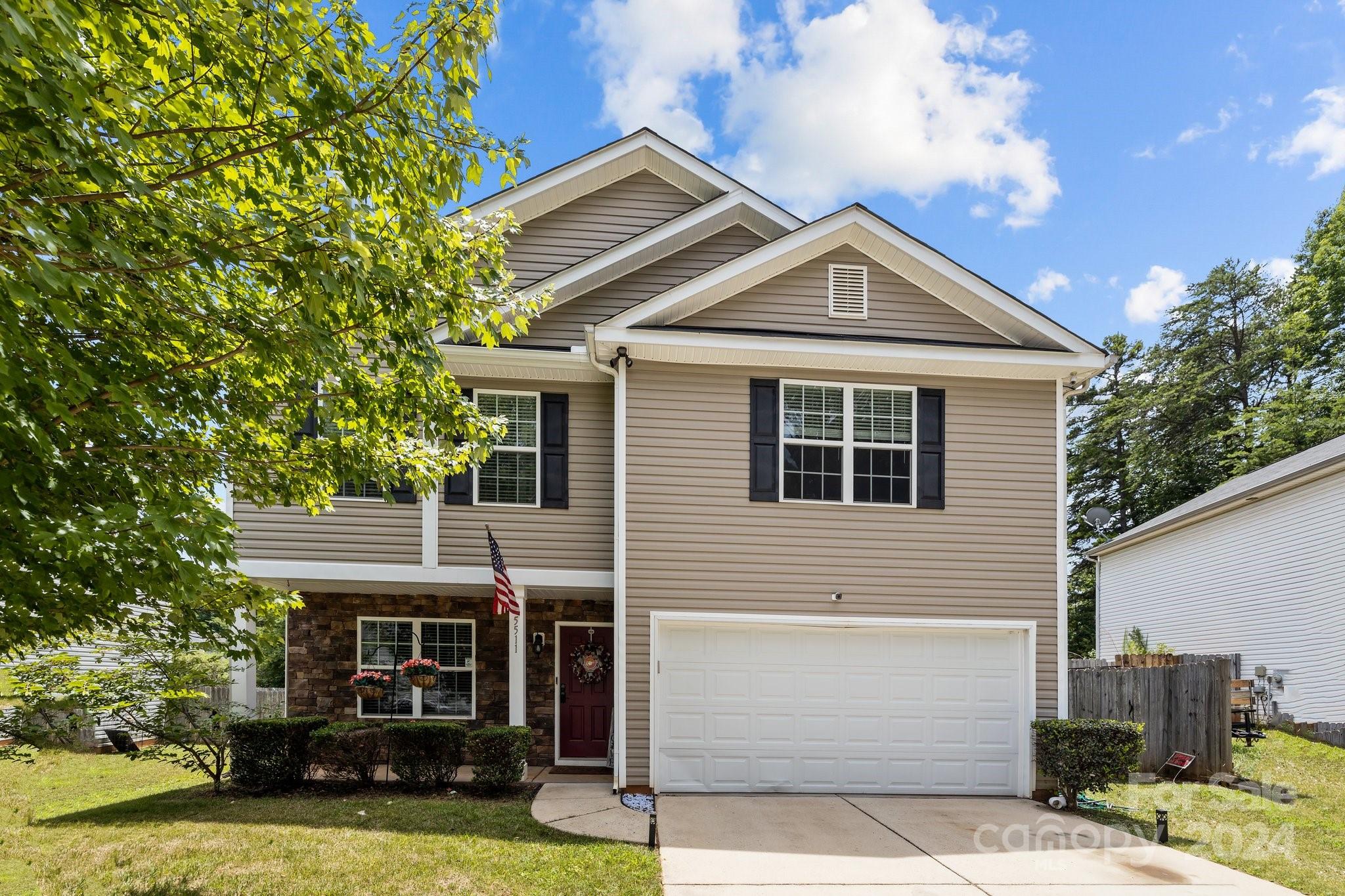 5511 Keener Ridge Road Charlotte, NC 28216 - Photo 28 of 31 a front view of a house with yard and garage