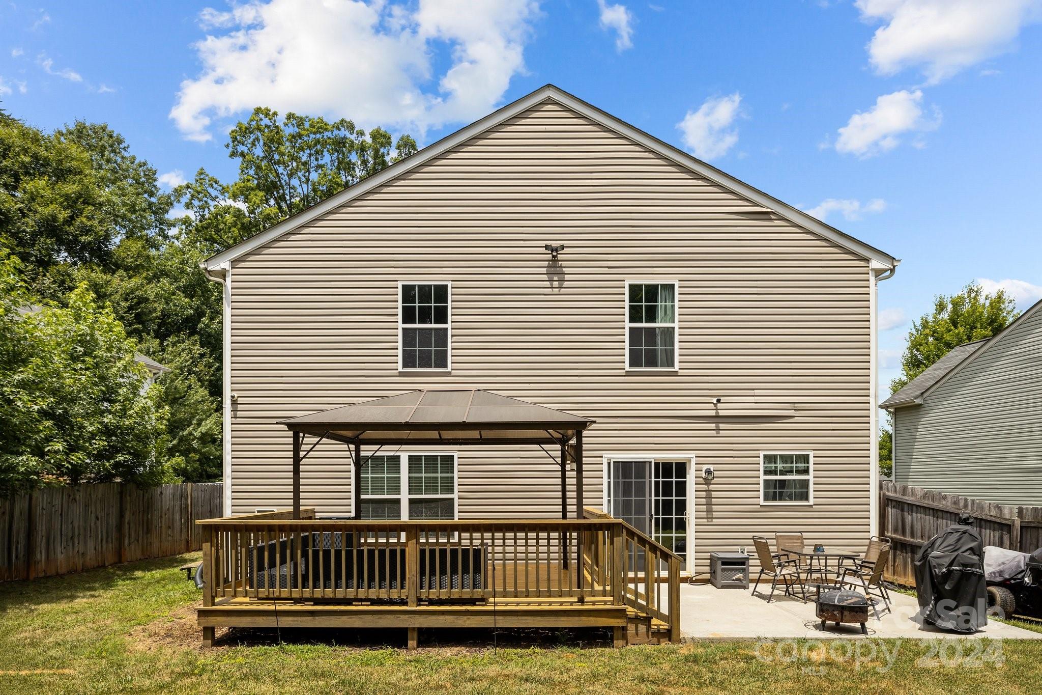 5511 Keener Ridge Road Charlotte, NC 28216 - Photo 29 of 31 a view of a house with a yard and deck