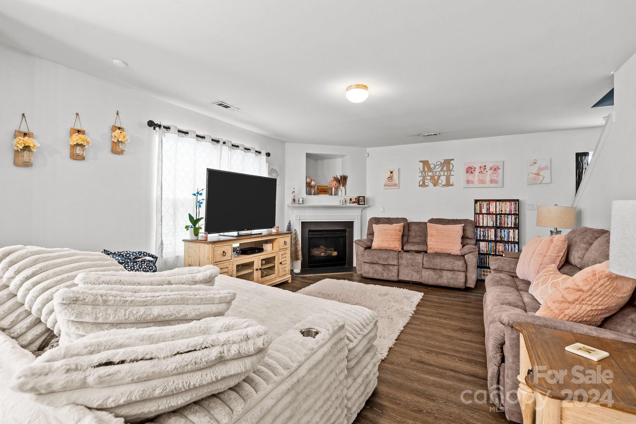5511 Keener Ridge Road Charlotte, NC 28216 - Photo 4 of 31 a bedroom with furniture and a flat screen tv