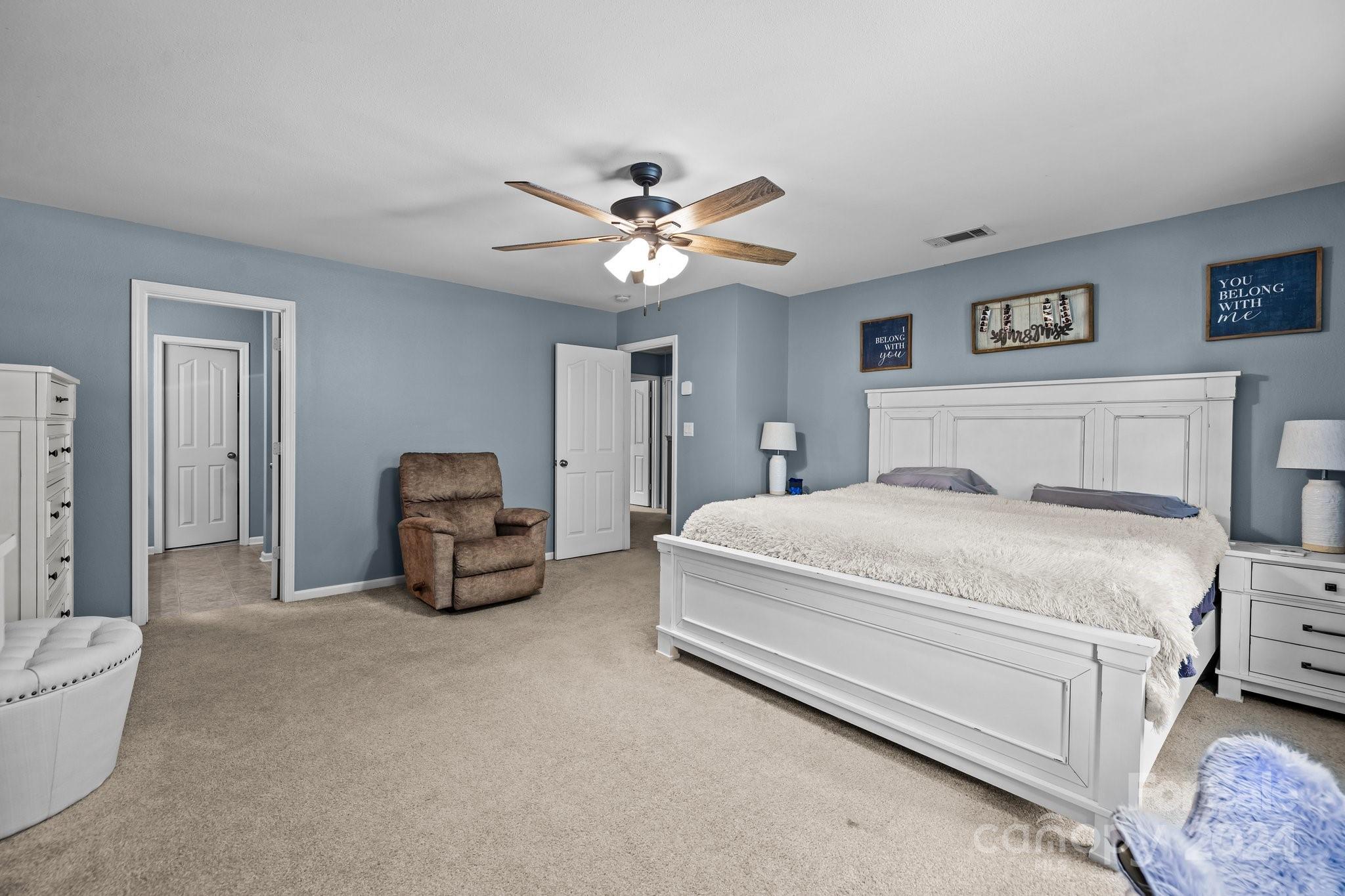 5511 Keener Ridge Road Charlotte, NC 28216 - Photo 5 of 31 a bedroom with a bed and a chandelier
