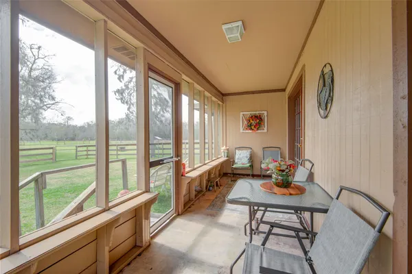 a room with furniture water view and large windows