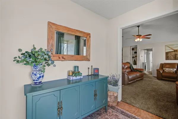 a living room with furniture and flowers