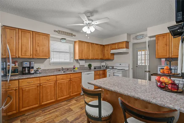 a kitchen with granite countertop lots of counter space and window