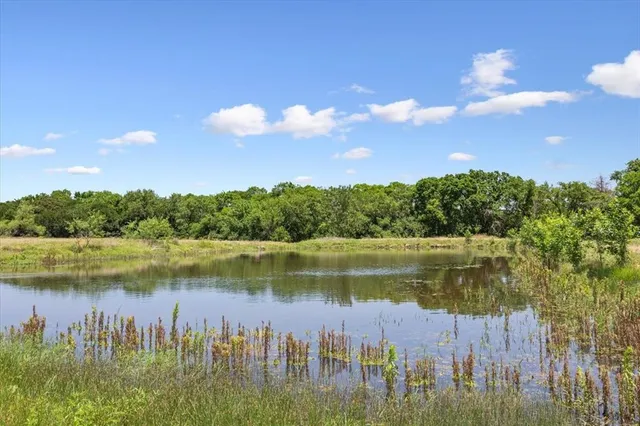 a view of a lake with houses in the back