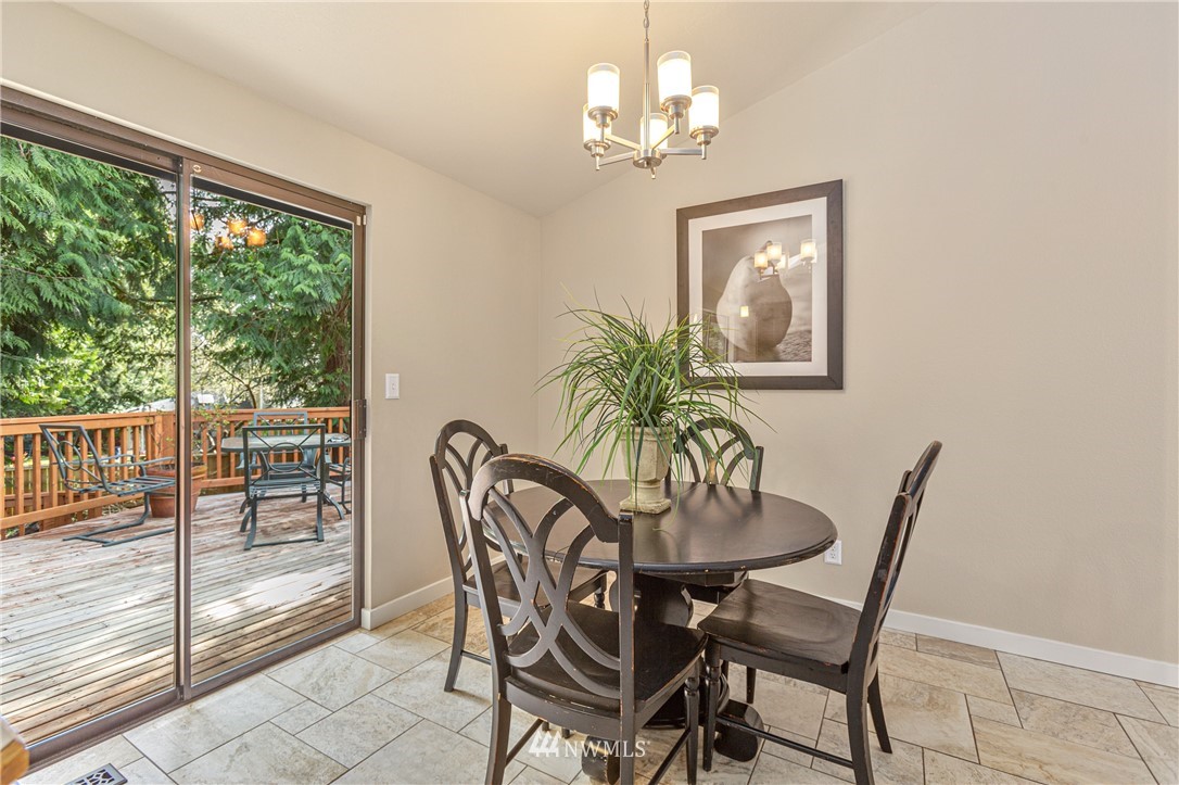 804 Duchess Road Bothell, WA 98012 - Photo 11 of 37 a dining room with furniture a chandelier and a rug