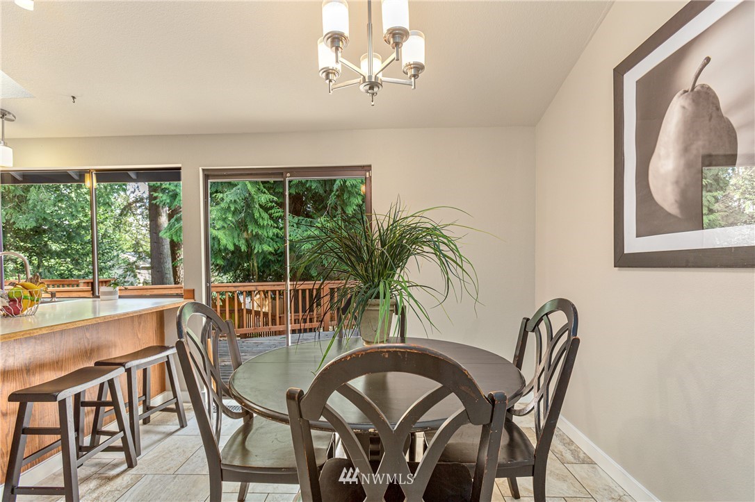 804 Duchess Road Bothell, WA 98012 - Photo 12 of 37 a dining room with furniture a large window and potted plants