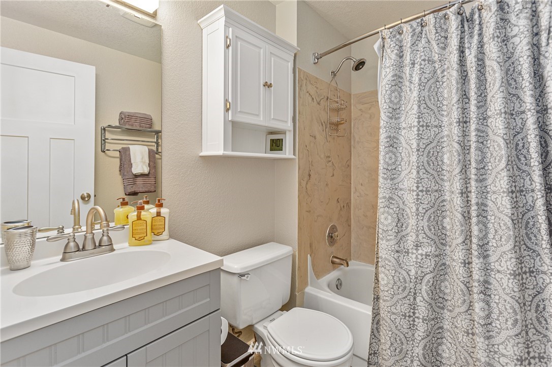 804 Duchess Road Bothell, WA 98012 - Photo 17 of 37 a bathroom with a sink a toilet and shower curtain