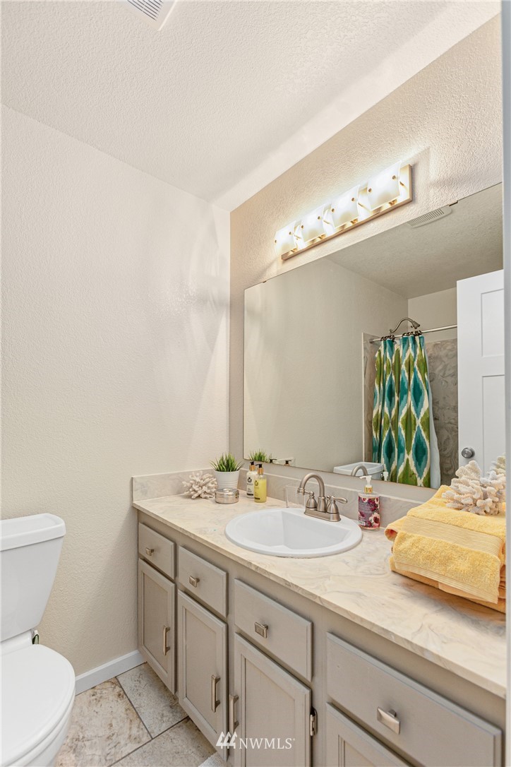 804 Duchess Road Bothell, WA 98012 - Photo 20 of 37 a bathroom with a sink and a mirror
