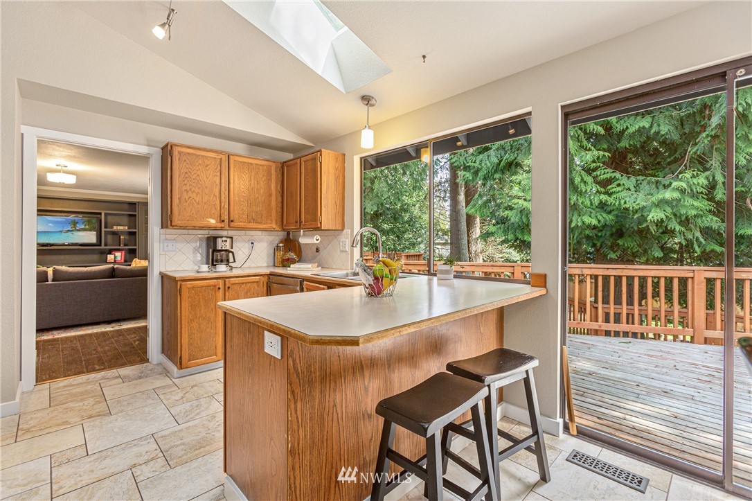 804 Duchess Road Bothell, WA 98012 - Photo 6 of 37 a kitchen with a sink a counter top space appliances and cabinets