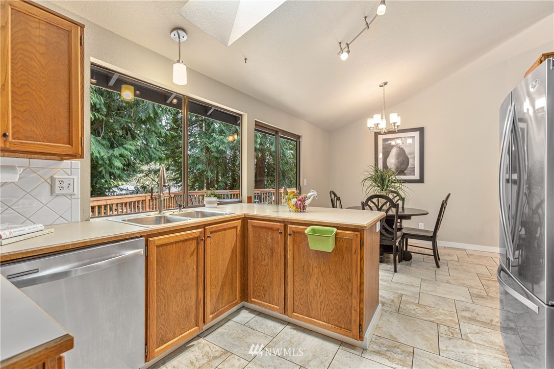 804 Duchess Road Bothell, WA 98012 - Photo 9 of 37 a open kitchen with stainless steel appliances granite countertop a sink and cabinets