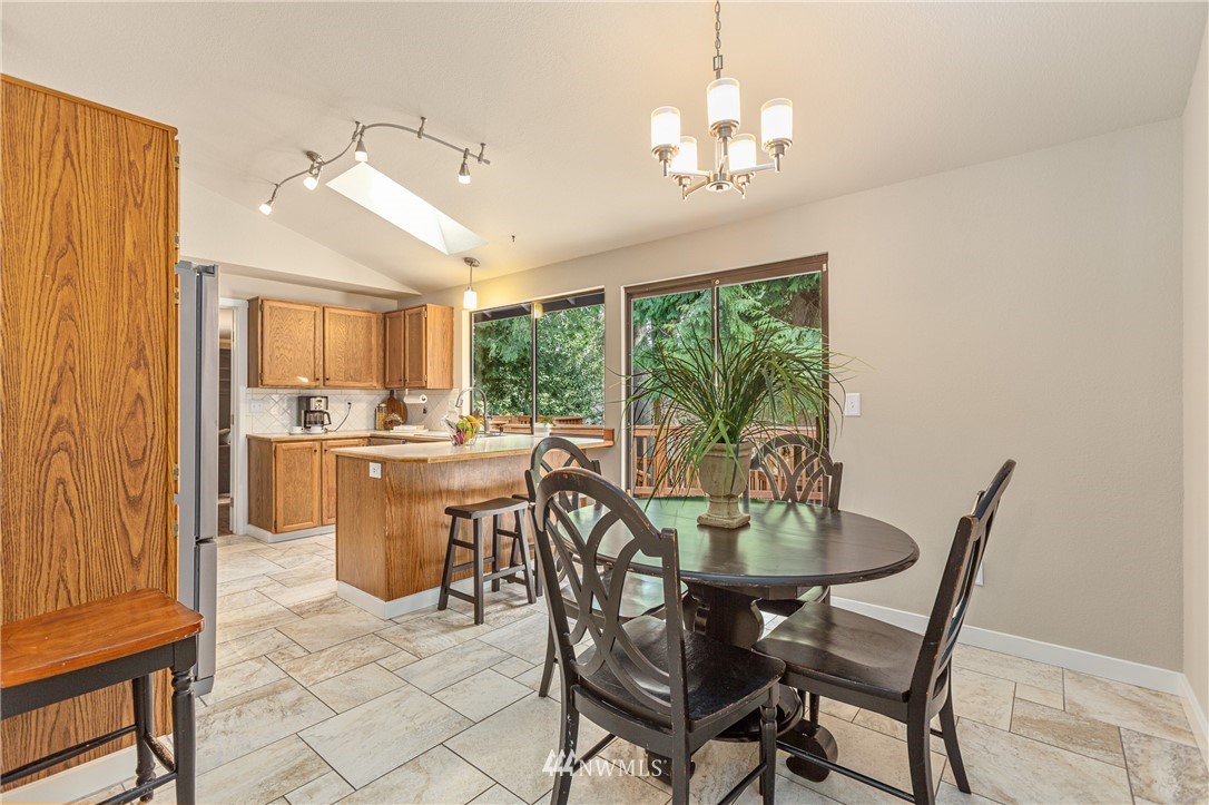 804 Duchess Road Bothell, WA 98012 - Photo 10 of 37 a dining room with furniture a chandelier and wooden floor