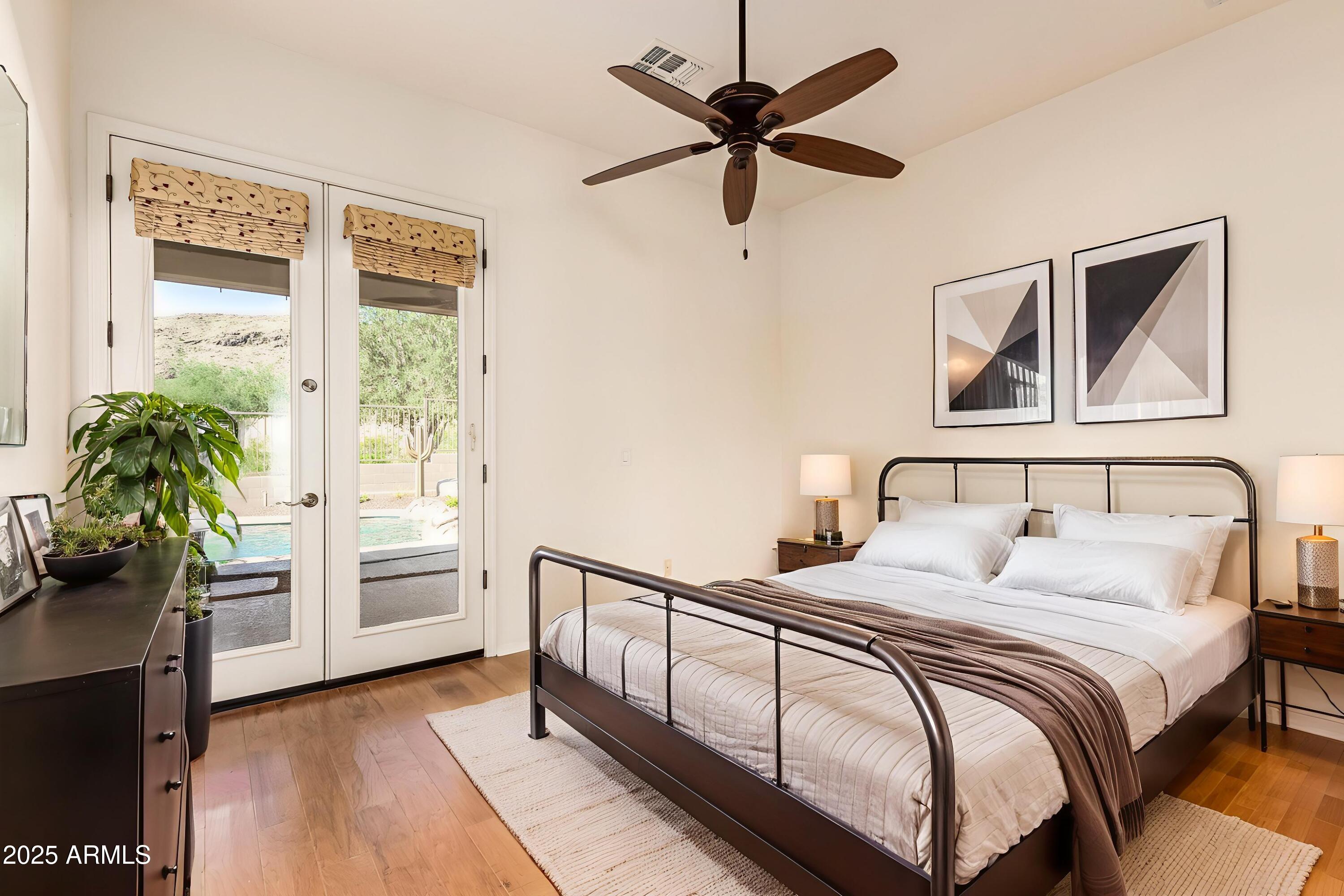 16030 South 27th Drive Phoenix, AZ 85045 - Photo 14 of 29 a bedroom with a large bed and a potted plant