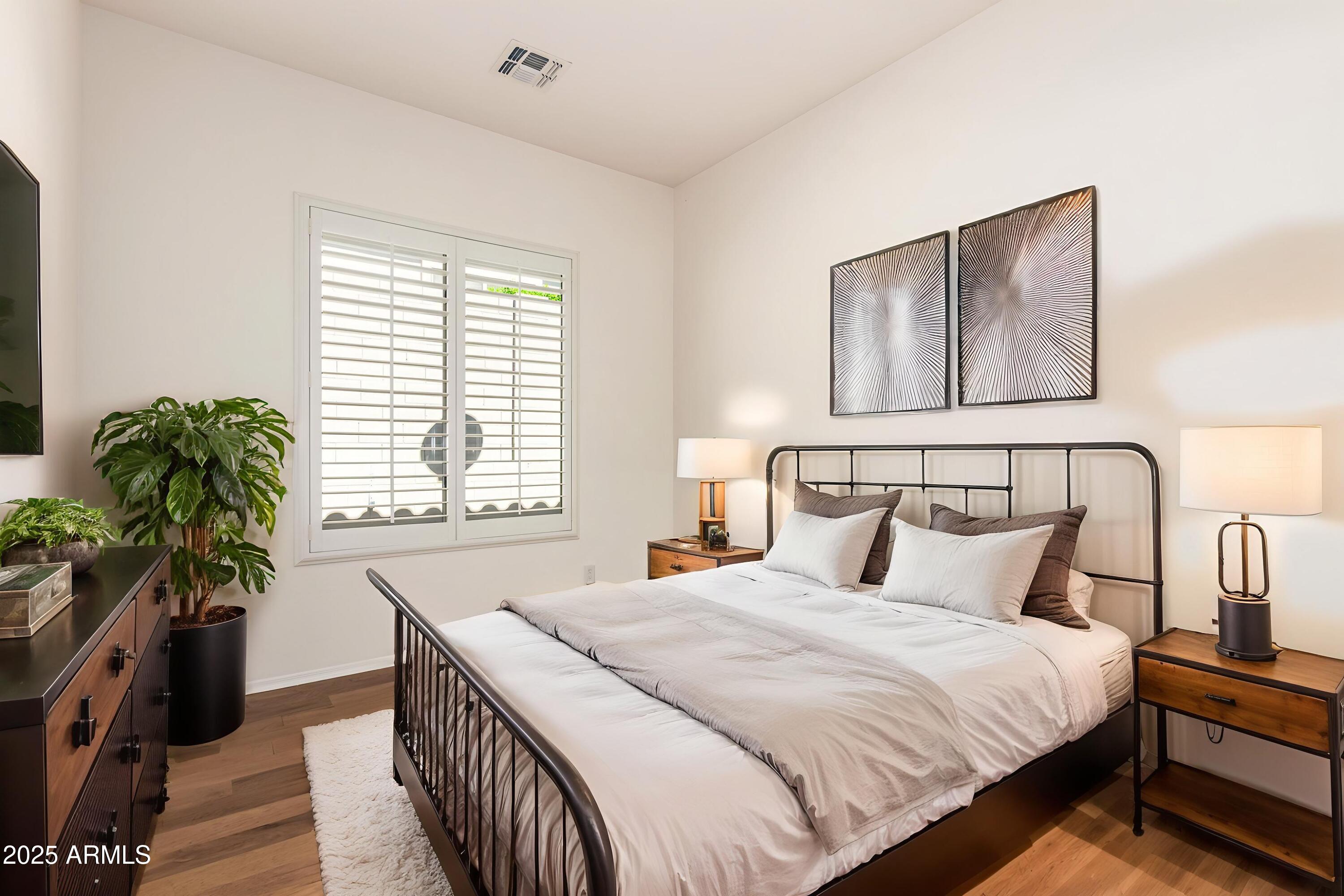 16030 South 27th Drive Phoenix, AZ 85045 - Photo 16 of 29 a bedroom with bed and a potted plant