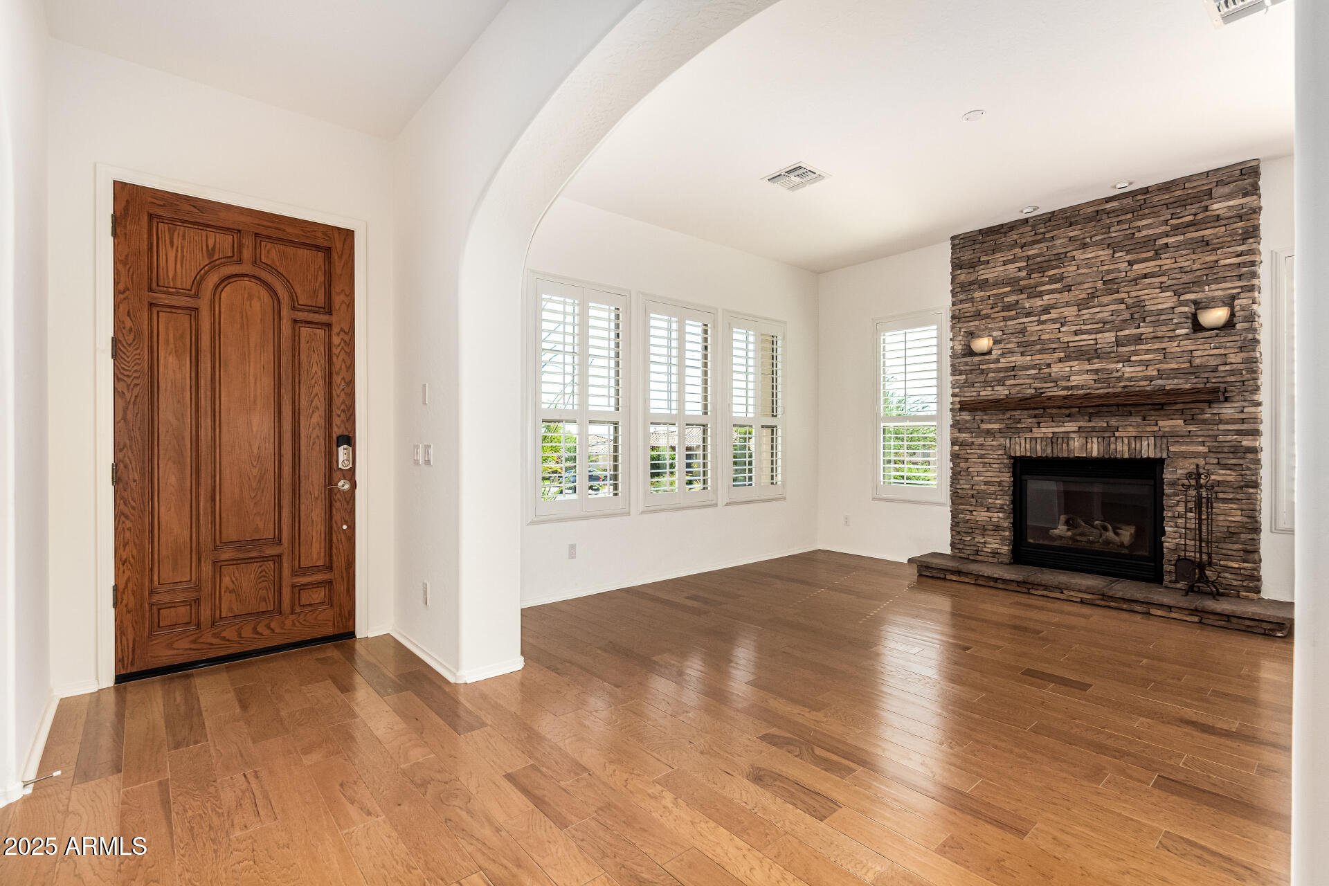 16030 South 27th Drive Phoenix, AZ 85045 - Photo 5 of 29 wooden floor fireplace and windows in an empty room
