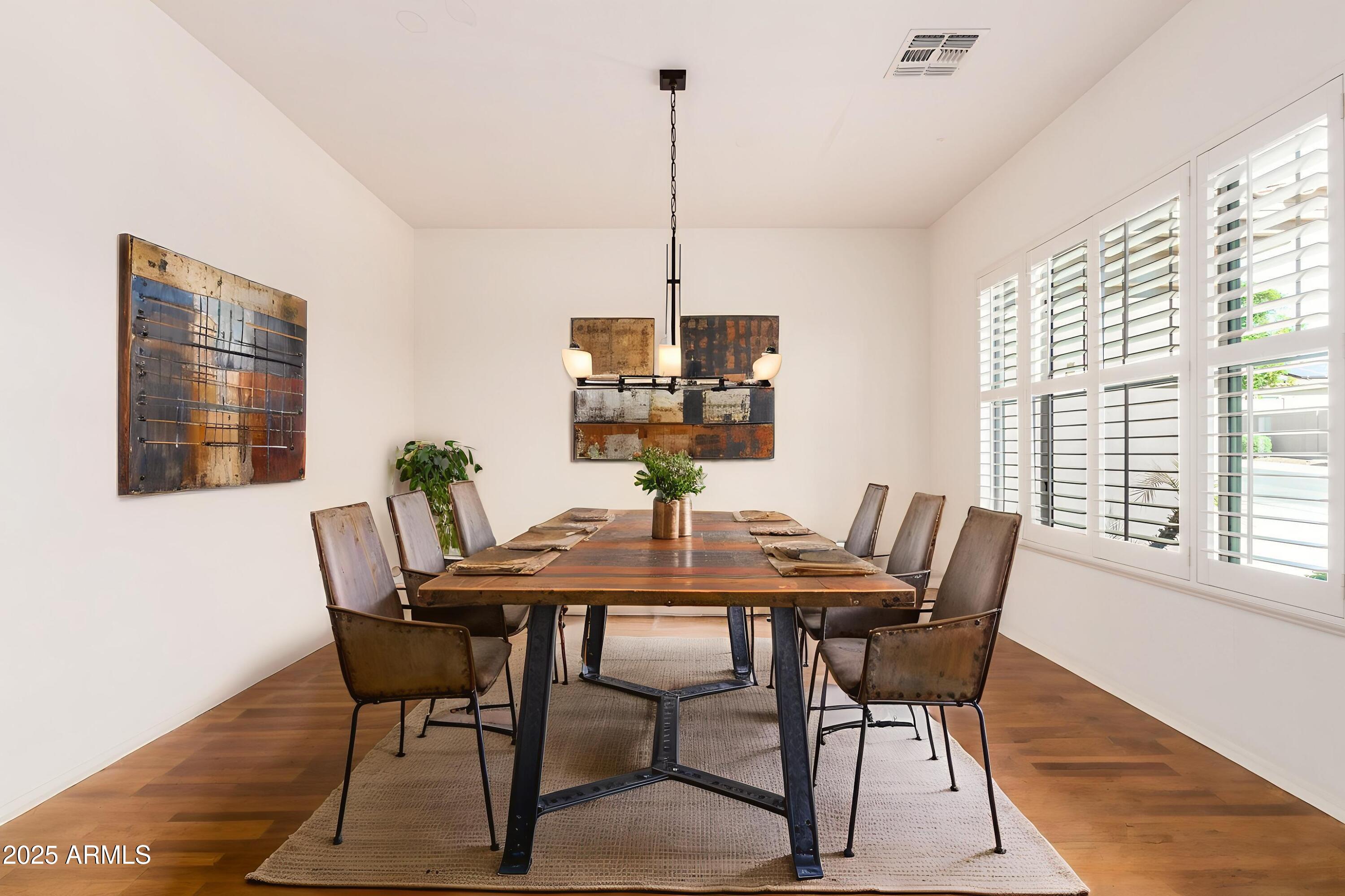 16030 South 27th Drive Phoenix, AZ 85045 - Photo 6 of 29 a view of a dining room with furniture window and wooden floor