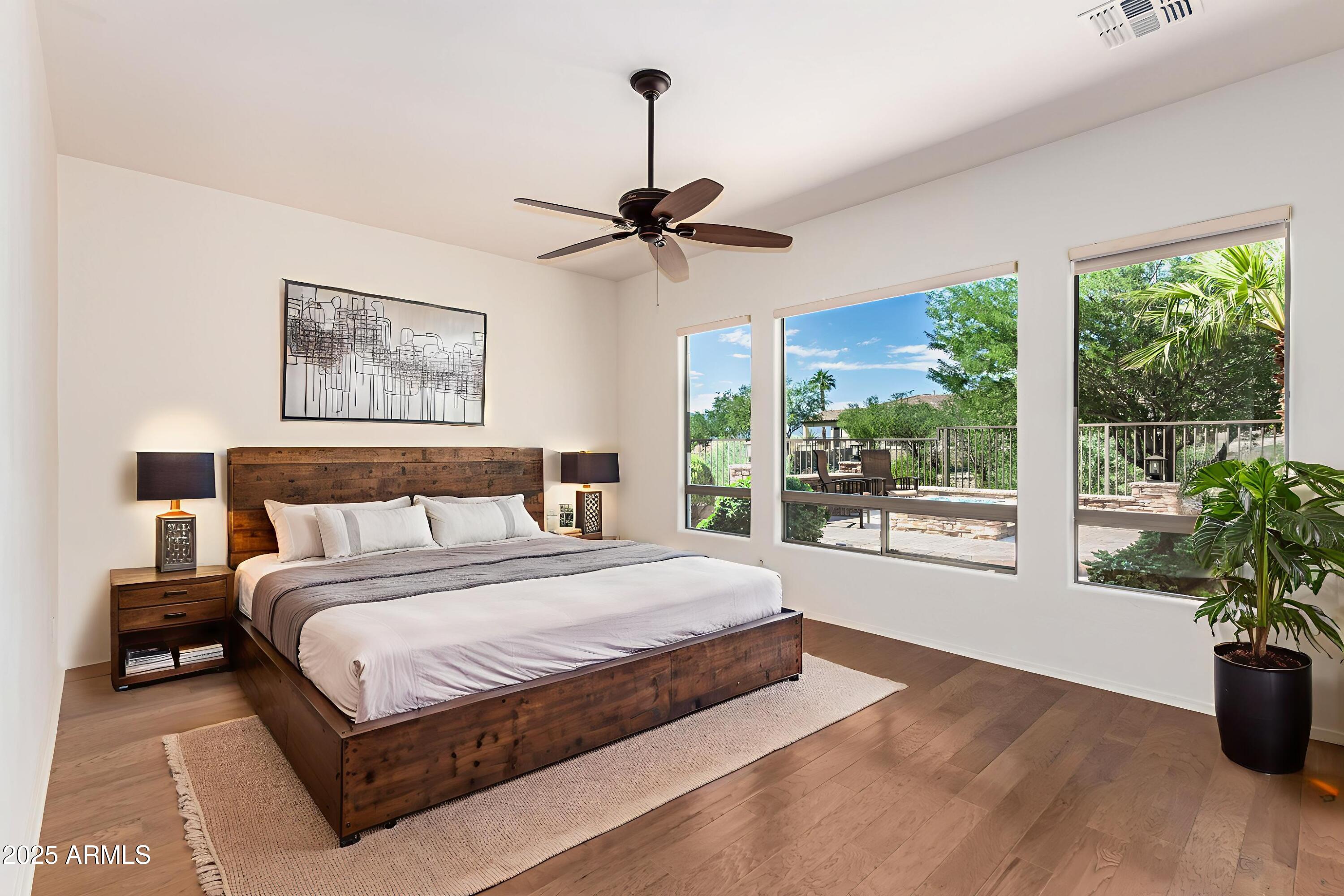 16030 South 27th Drive Phoenix, AZ 85045 - Photo 10 of 29 a spacious bedroom with a large bed and a chandelier