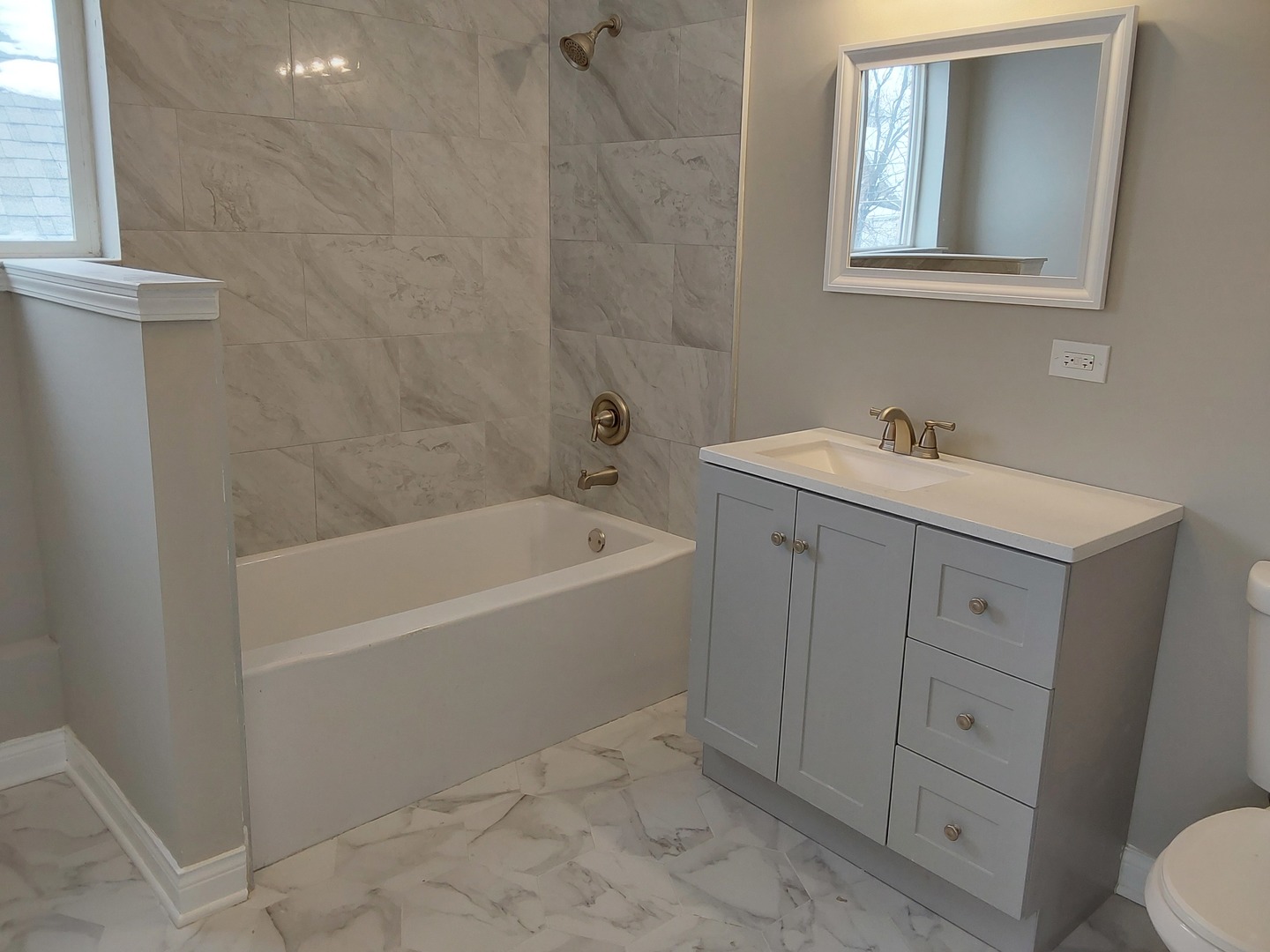 7712 South Evans Avenue Chicago, IL 60619 - Photo 14 of 22 a bathroom with a sink a toilet and vanity