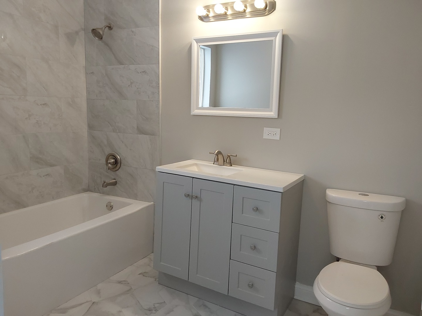 7712 South Evans Avenue Chicago, IL 60619 - Photo 15 of 22 a bathroom with a sink a toilet and bathtub