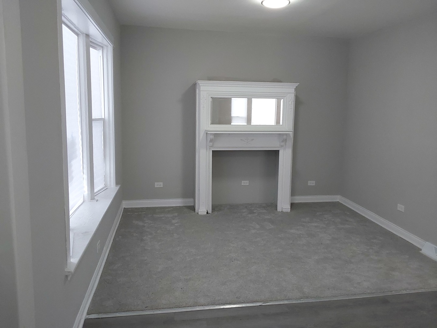 7712 South Evans Avenue Chicago, IL 60619 - Photo 2 of 22 an empty room that has a fireplace in it