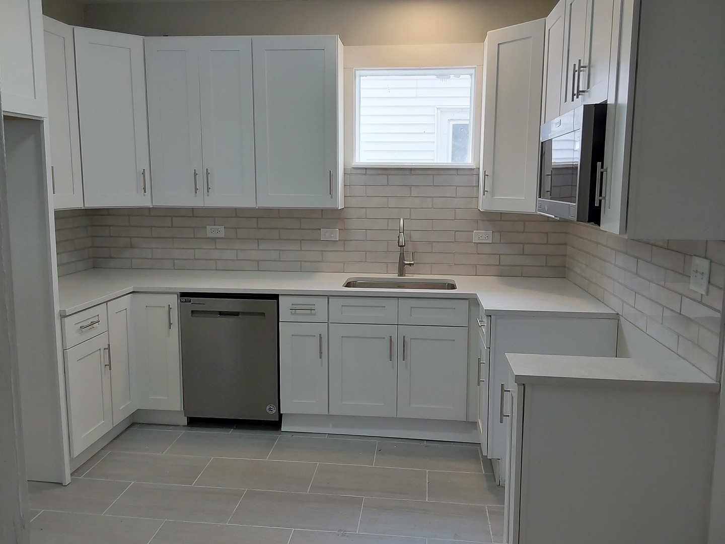 7712 South Evans Avenue Chicago, IL 60619 - Photo 6 of 22 a kitchen with white cabinets sink and dishwasher