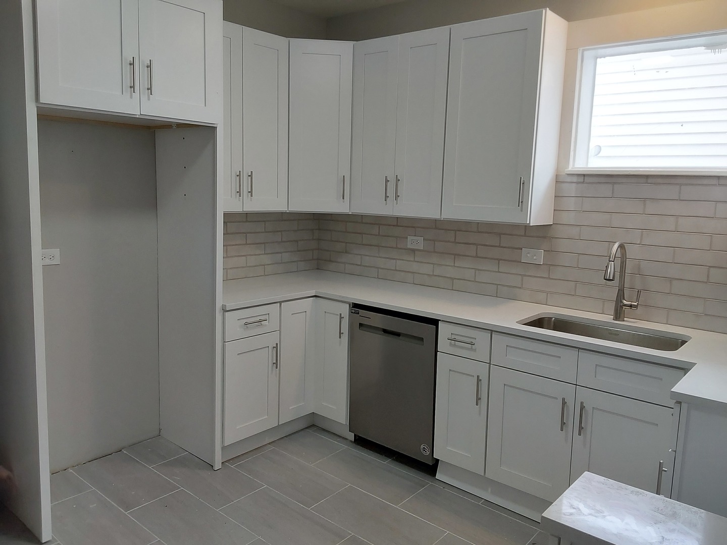 7712 South Evans Avenue Chicago, IL 60619 - Photo 7 of 22 a kitchen with white cabinets and sink