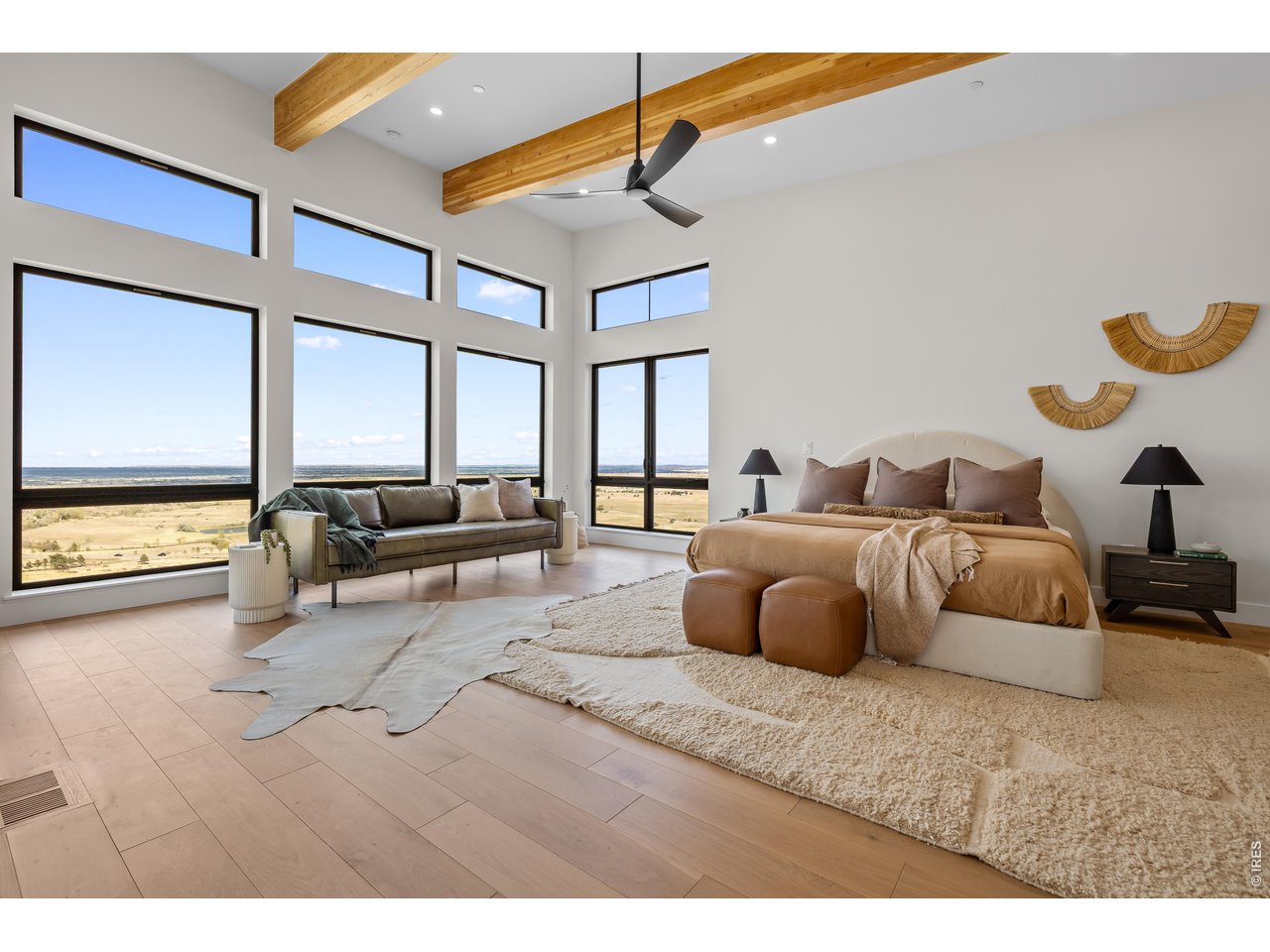 9578 Mountain Ridge Drive Boulder, CO 80302 - Photo 20 of 47 a bedroom with a large bed and a chandelier