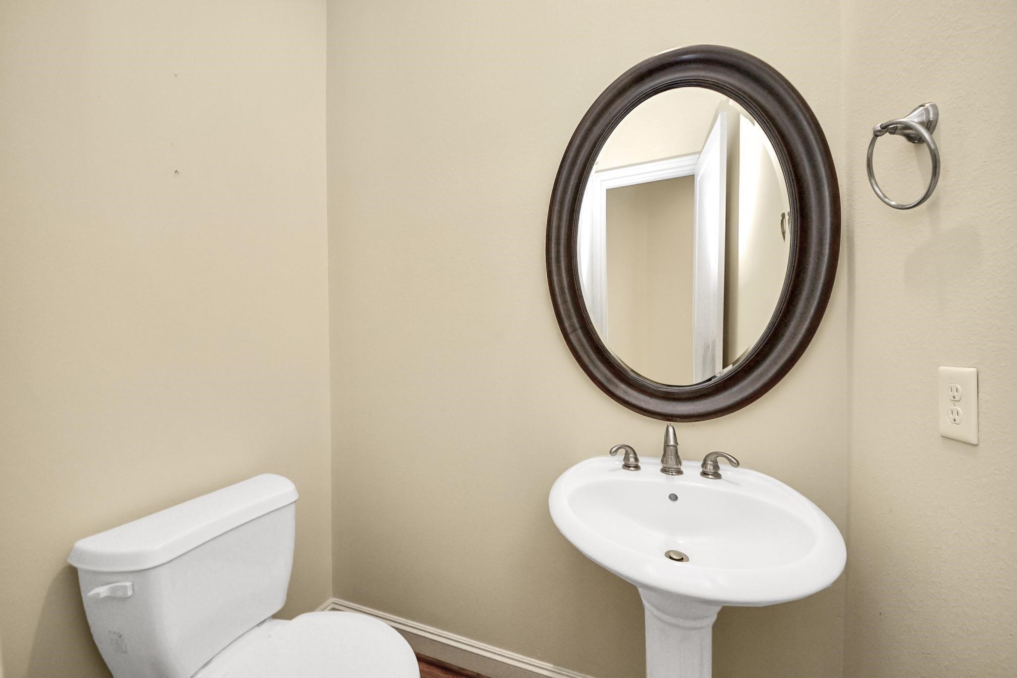 5617 Kiam Street, Unit A Houston, TX 77007 - Photo 11 of 46 a bathroom with a sink a mirror and a toilet