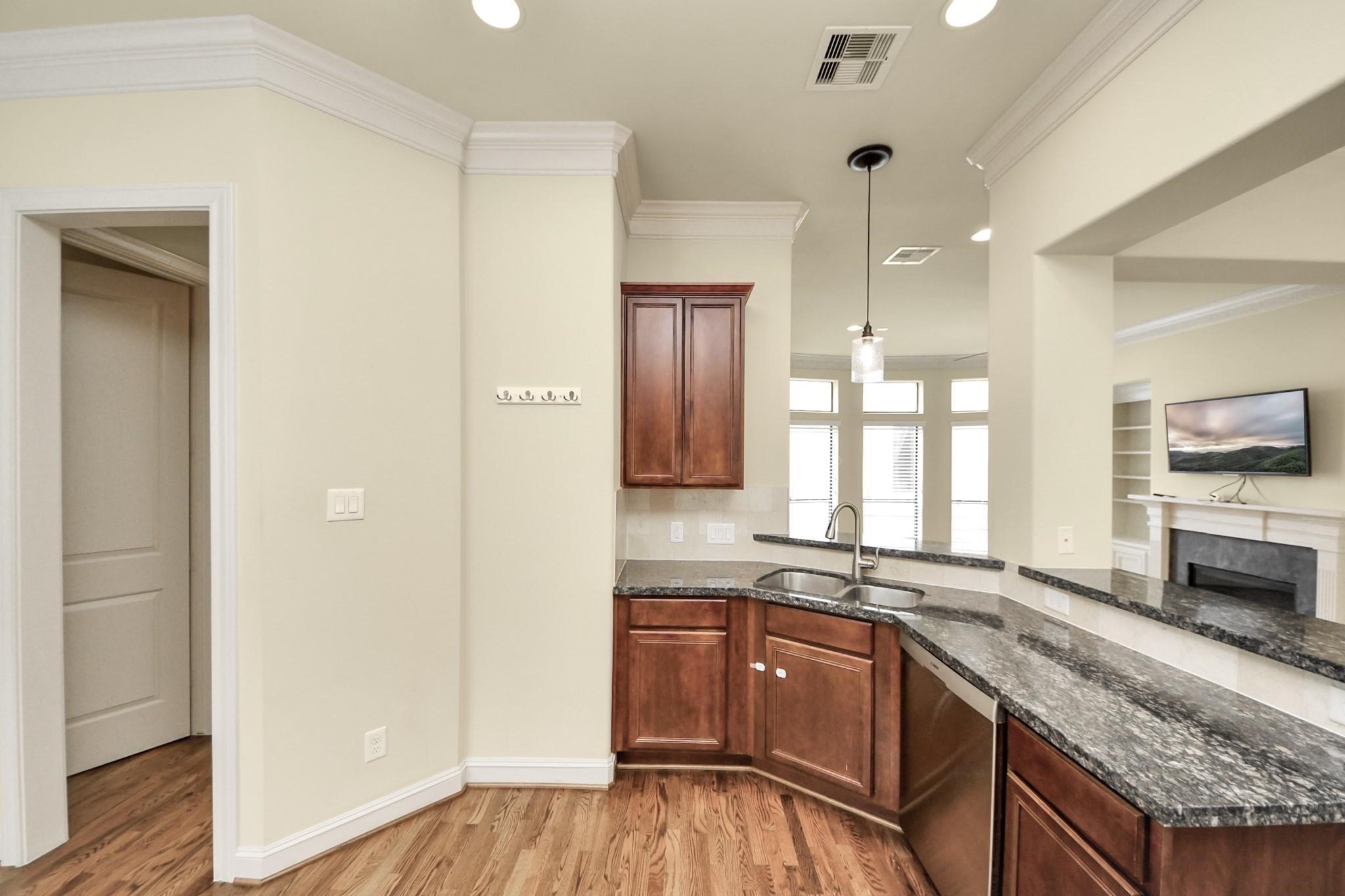 5617 Kiam Street, Unit A Houston, TX 77007 - Photo 12 of 46 a kitchen with granite countertop a stove a sink and a refrigerator
