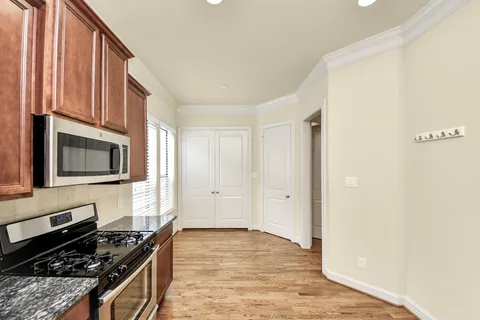 a kitchen with stainless steel appliances granite countertop a stove and a microwave