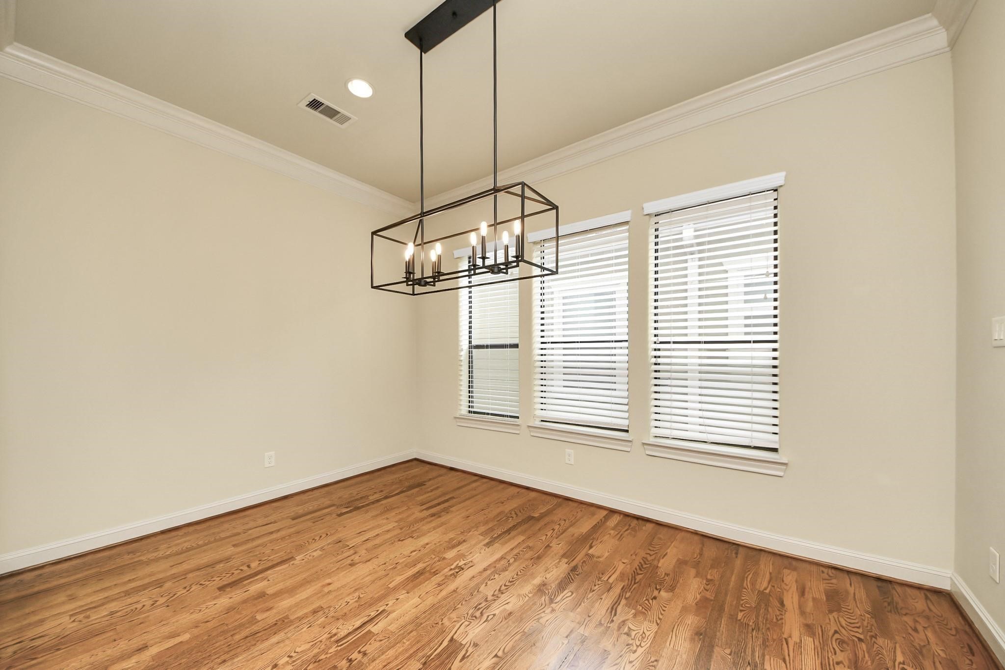 5617 Kiam Street, Unit A Houston, TX 77007 - Photo 18 of 46 a view of a room with a window and wooden floor