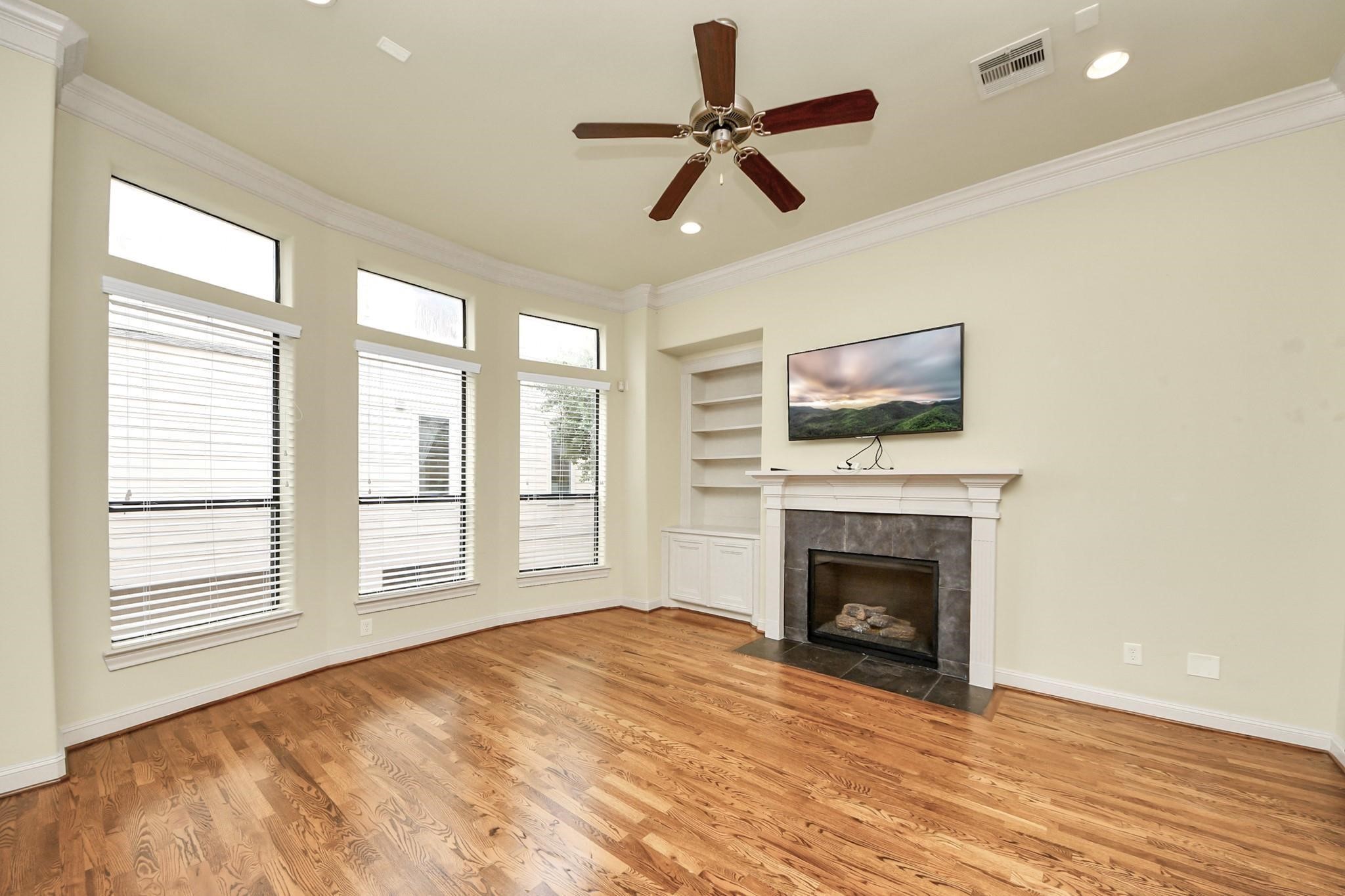 5617 Kiam Street, Unit A Houston, TX 77007 - Photo 22 of 46 a view of empty room with fireplace wooden floor and windows