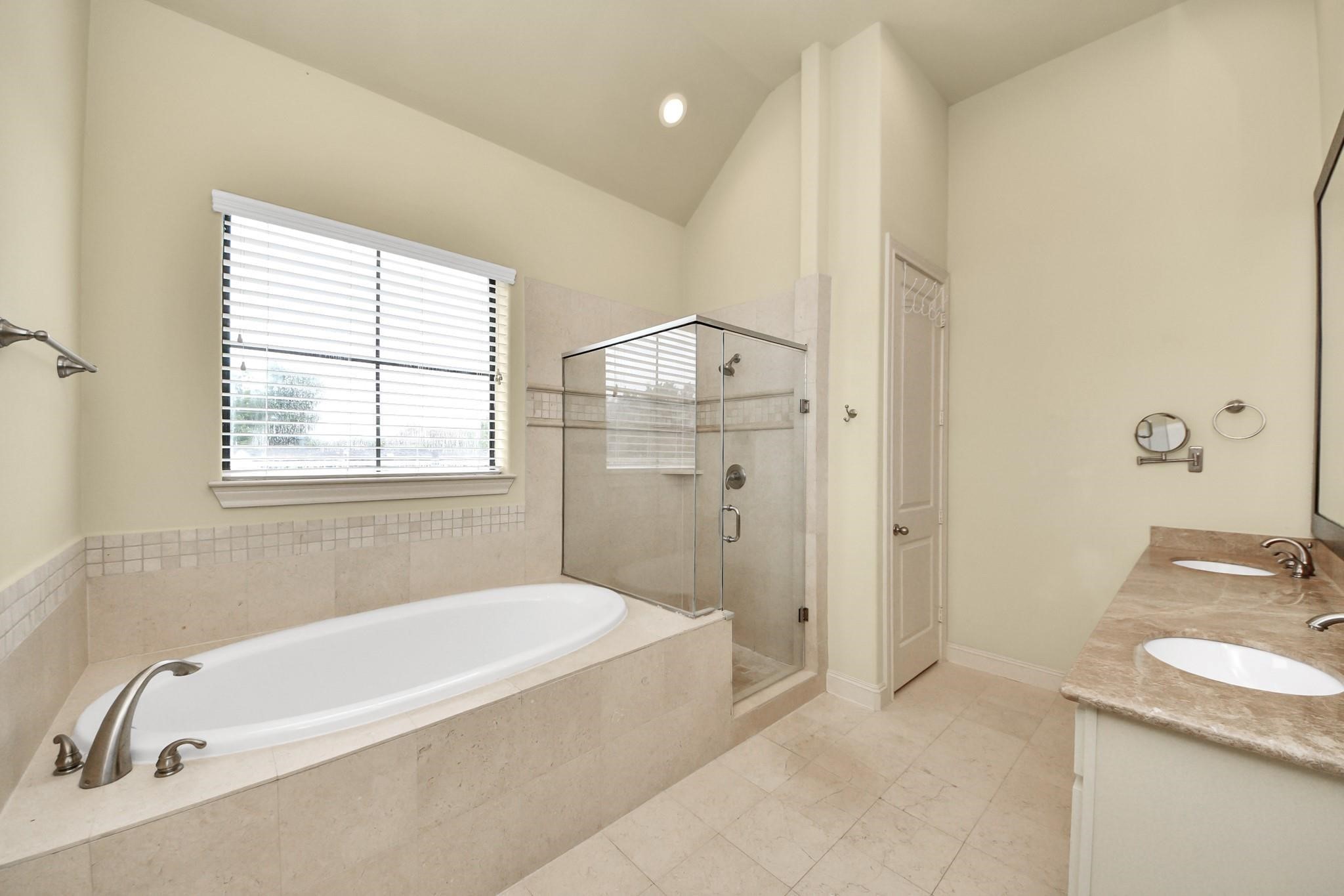 5617 Kiam Street, Unit A Houston, TX 77007 - Photo 30 of 46 a bathroom with a granite countertop tub sink and mirror