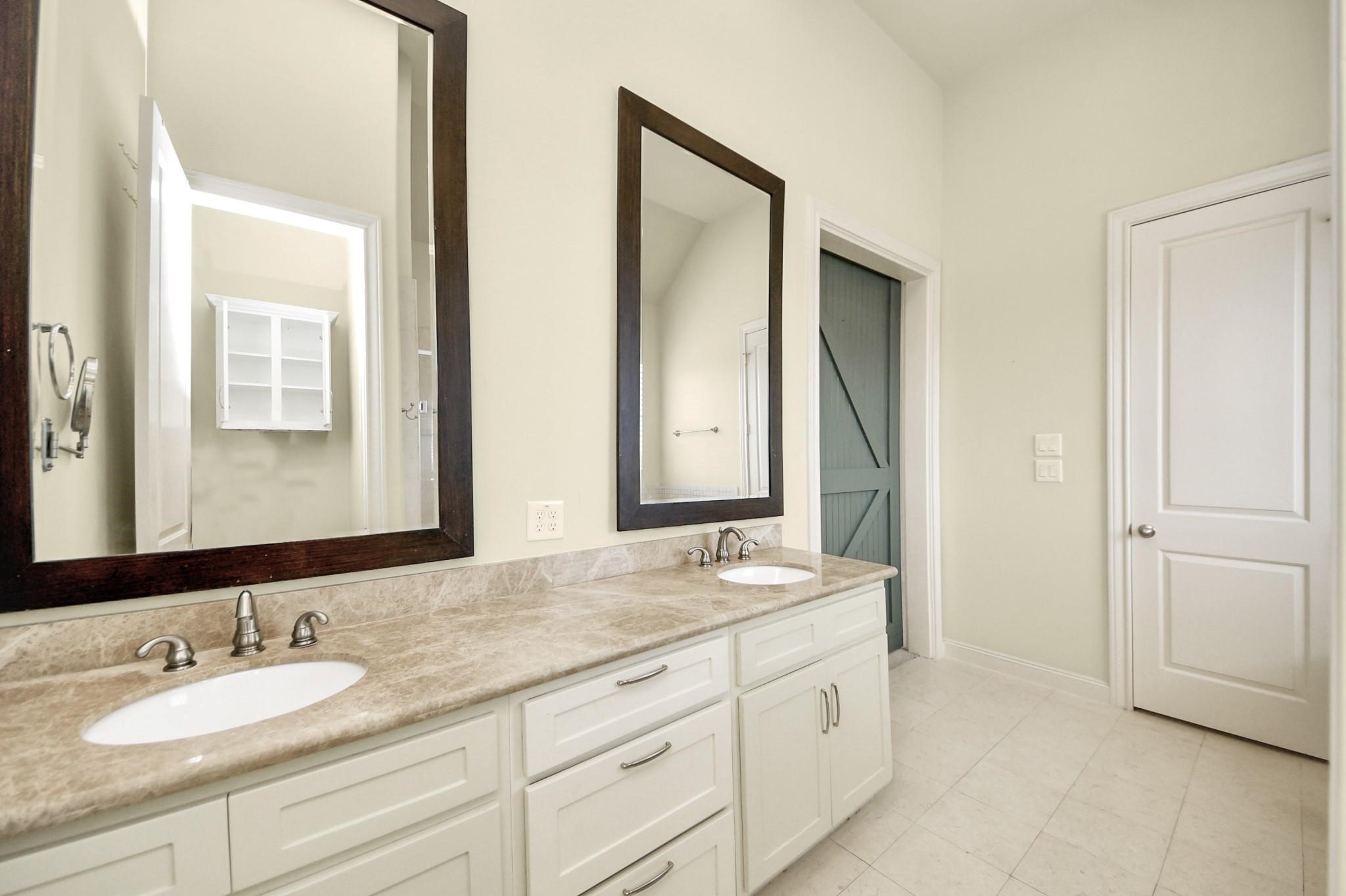 5617 Kiam Street, Unit A Houston, TX 77007 - Photo 33 of 46 a bathroom with double sink and a mirror