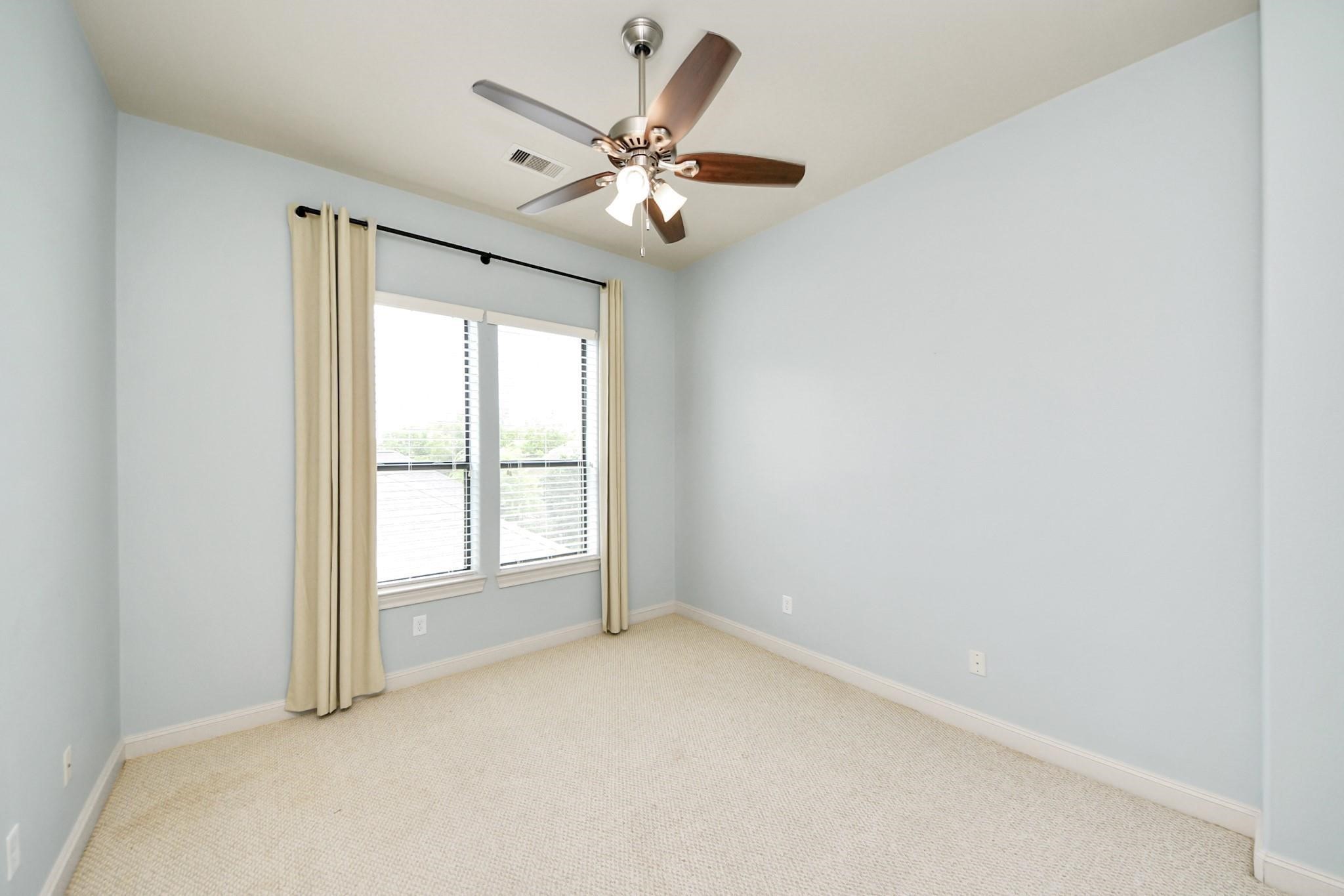 5617 Kiam Street, Unit A Houston, TX 77007 - Photo 39 of 46 an empty room with windows and fan