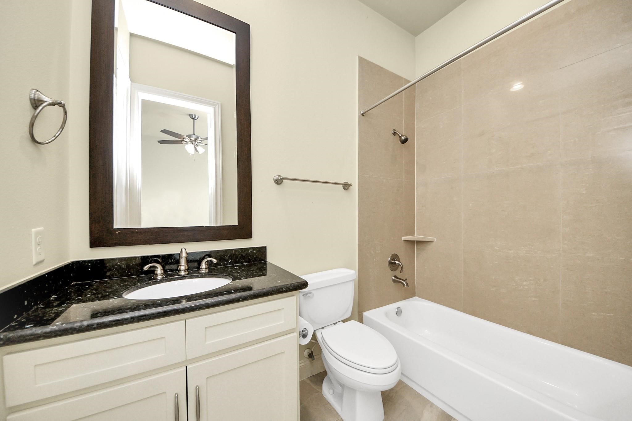 5617 Kiam Street, Unit A Houston, TX 77007 - Photo 40 of 46 a bathroom with a granite countertop sink toilet and shower