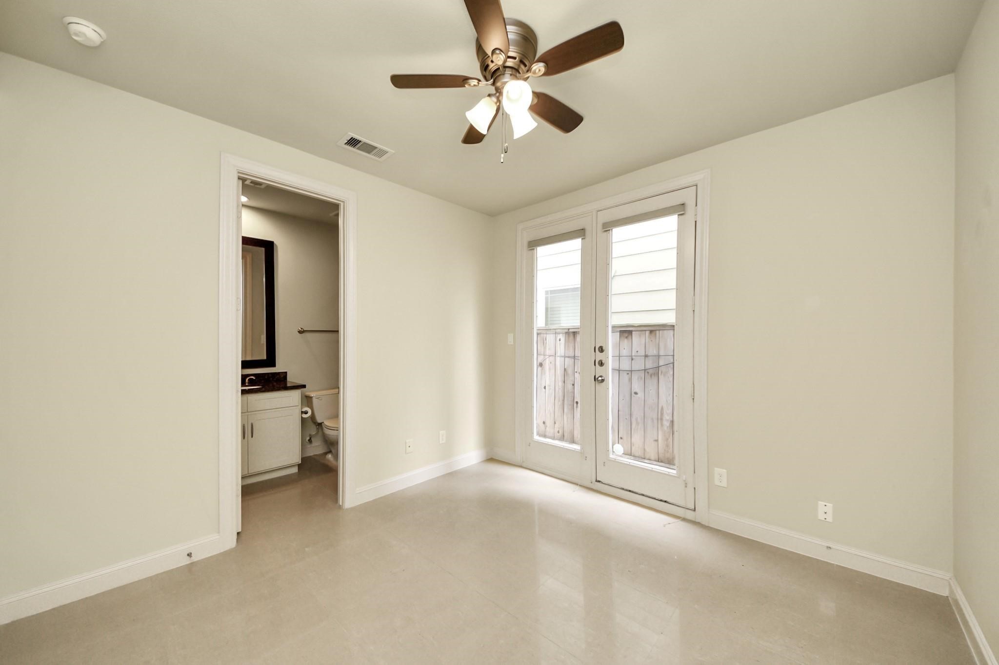 5617 Kiam Street, Unit A Houston, TX 77007 - Photo 6 of 46 an empty room with chandelier fan and windows