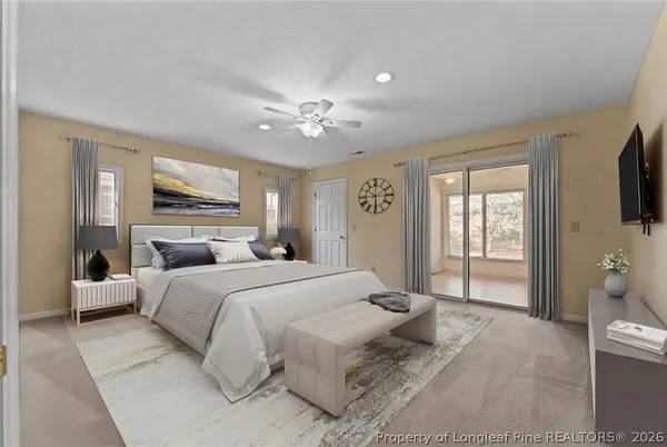 a bedroom with a large bed and a flat screen tv