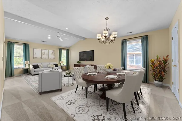 a view of a dining room with furniture and window