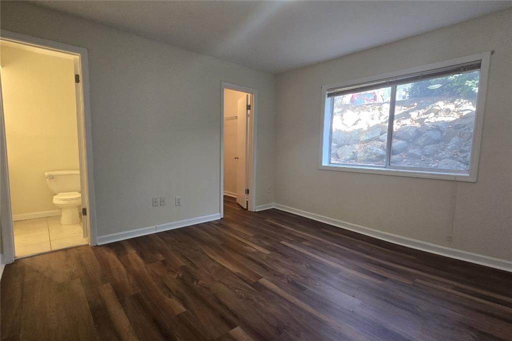 1418 Foxhall Lane Southeast, Unit 8 Atlanta, GA 30316 - Photo 19 of 41 a view of an empty room with wooden floor and a window