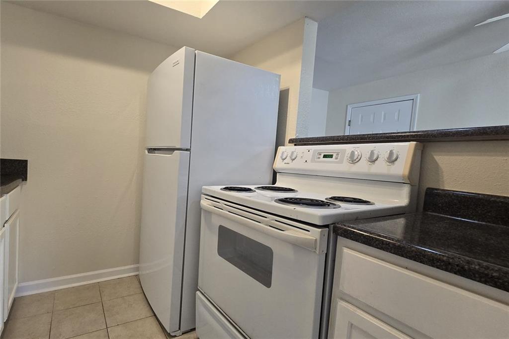 1418 Foxhall Lane Southeast, Unit 8 Atlanta, GA 30316 - Photo 23 of 50 a kitchen with a stove and a refrigerator