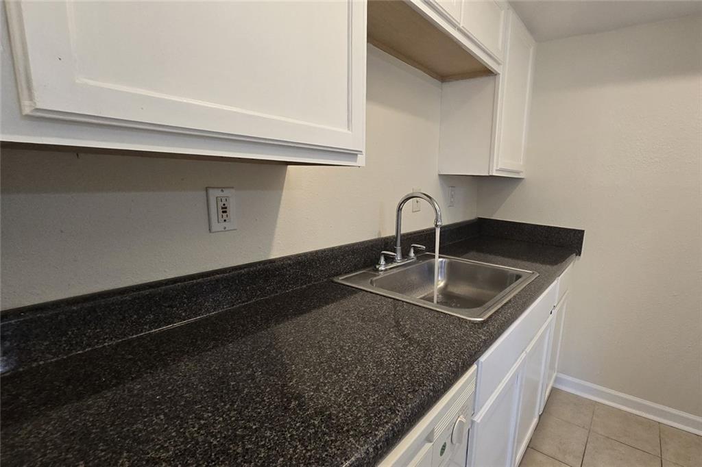 1418 Foxhall Lane Southeast, Unit 8 Atlanta, GA 30316 - Photo 24 of 50 a kitchen with granite countertop a sink and cabinets