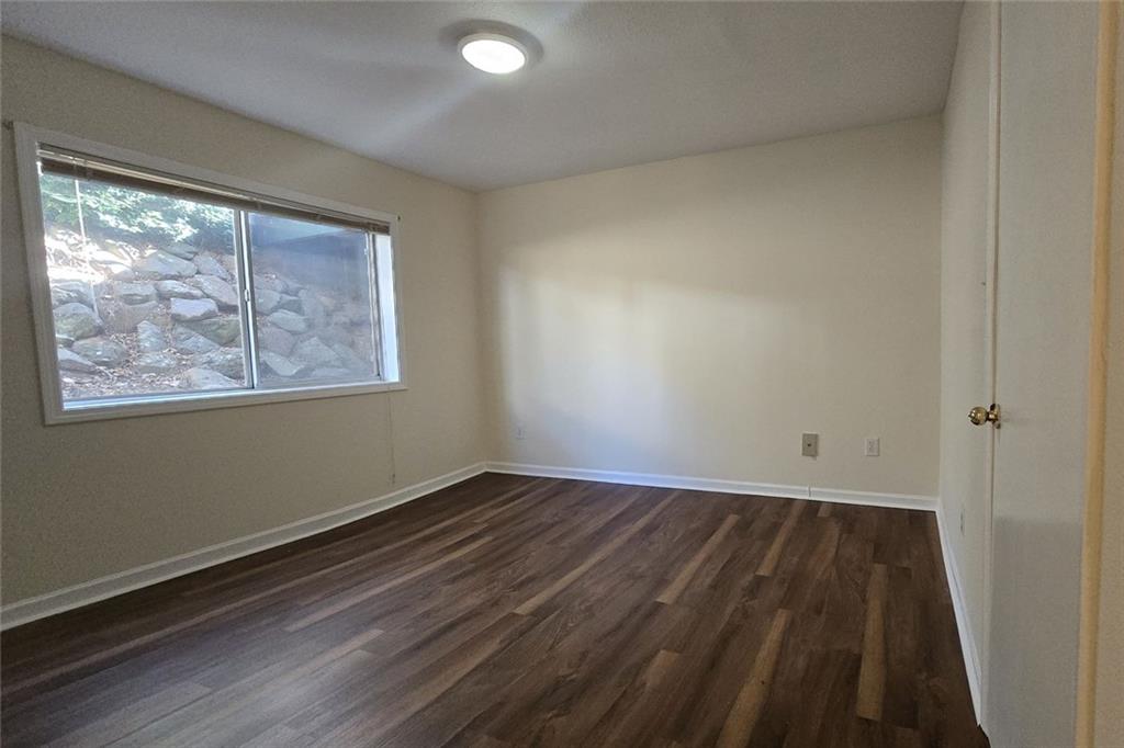 1418 Foxhall Lane Southeast, Unit 8 Atlanta, GA 30316 - Photo 25 of 50 a view of an empty room with wooden floor and a window
