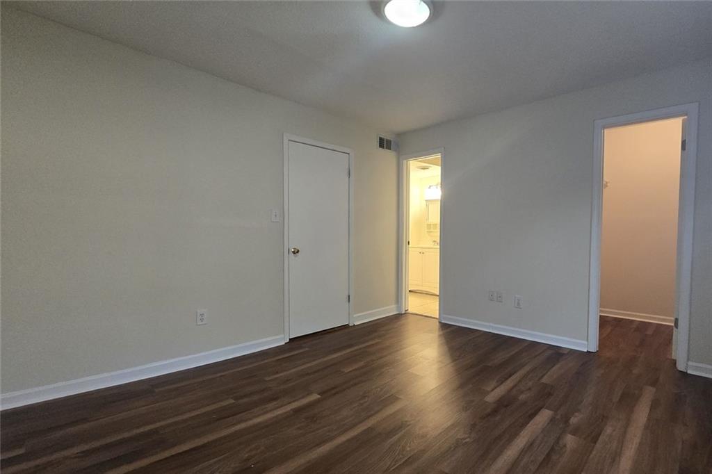1418 Foxhall Lane Southeast, Unit 8 Atlanta, GA 30316 - Photo 27 of 50 a view of an empty room with wooden floor and a window