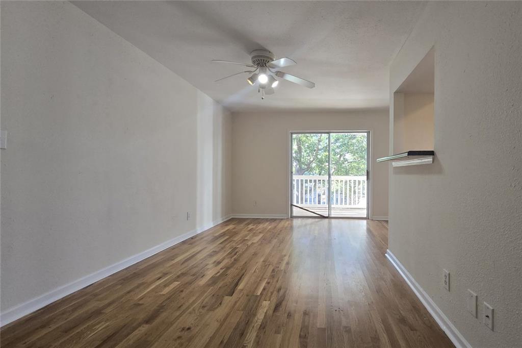 1418 Foxhall Lane Southeast, Unit 8 Atlanta, GA 30316 - Photo 5 of 41 a view of an empty room with wooden floor and a window