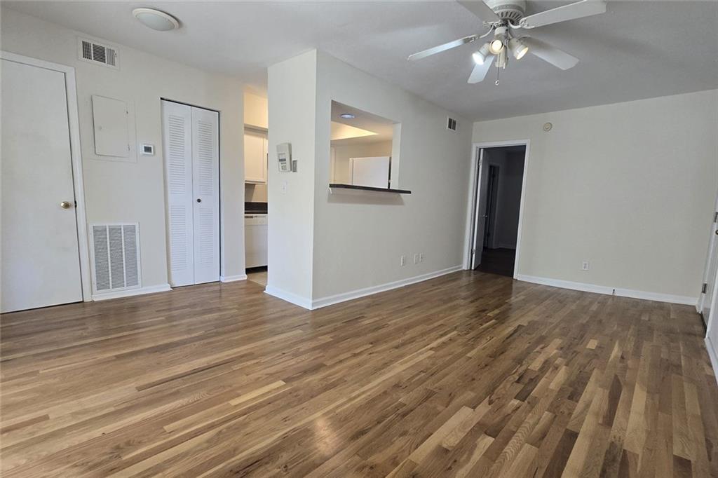 1418 Foxhall Lane Southeast, Unit 8 Atlanta, GA 30316 - Photo 9 of 41 a view of an empty room with wooden floor and a window