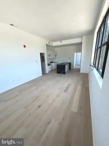 a view of an empty room with a fireplace