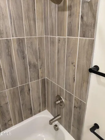 a bathroom with a shower and a sink